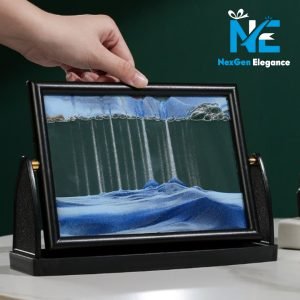Hand flipping black sand motion display with blue and white sand mixture forming new flowing patterns