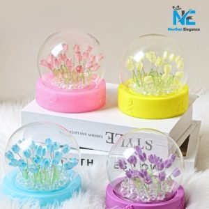 Decorative tulip glow lamps in four colors, purple, blue, pink, and yellow, under glass domes with LED glow on colorful bases