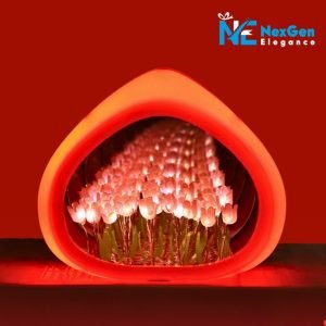 Close-up of a pink droplet-shaped Love Tulip Night Light. Soft magenta glow highlights rows of pink and white tulip LED flowers. Lamp on dark surface with magenta background.