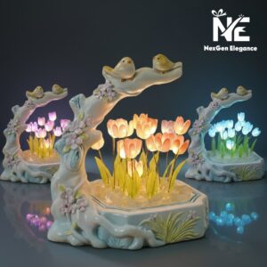 Three different Tulip Bird Glow lamps (Purple, Orange/Pink, and Blue) arranged together to show the variety of color options available.